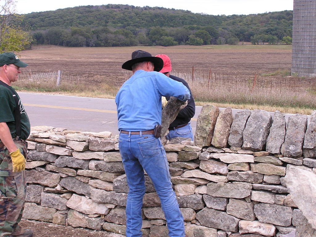 Work being done to restore a stretch of stone fencing at the inaugural stone fence workshop in 2007.